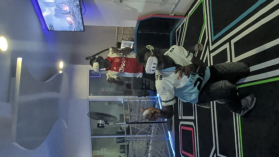 Young players sharing a guided multiplayer VR arena session at Player One
