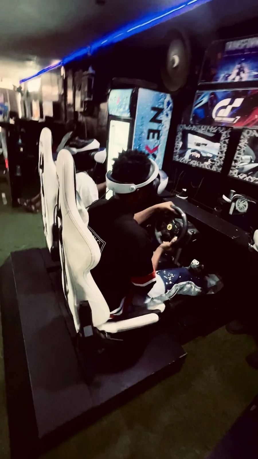 A young player using a racing simulator at the Player One Yaba branch