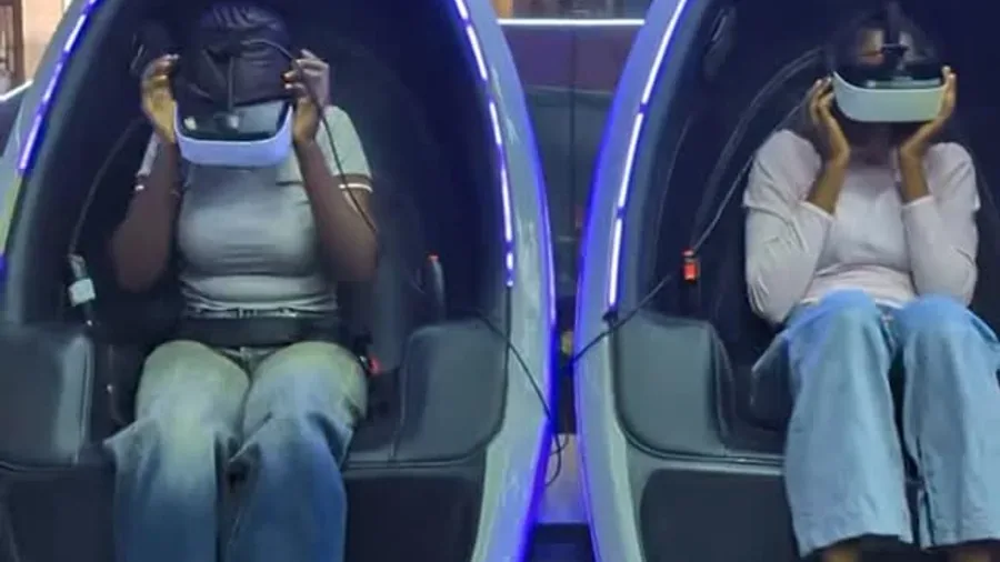 Two guests sharing a VR pod date night experience at Player One Game Cafe