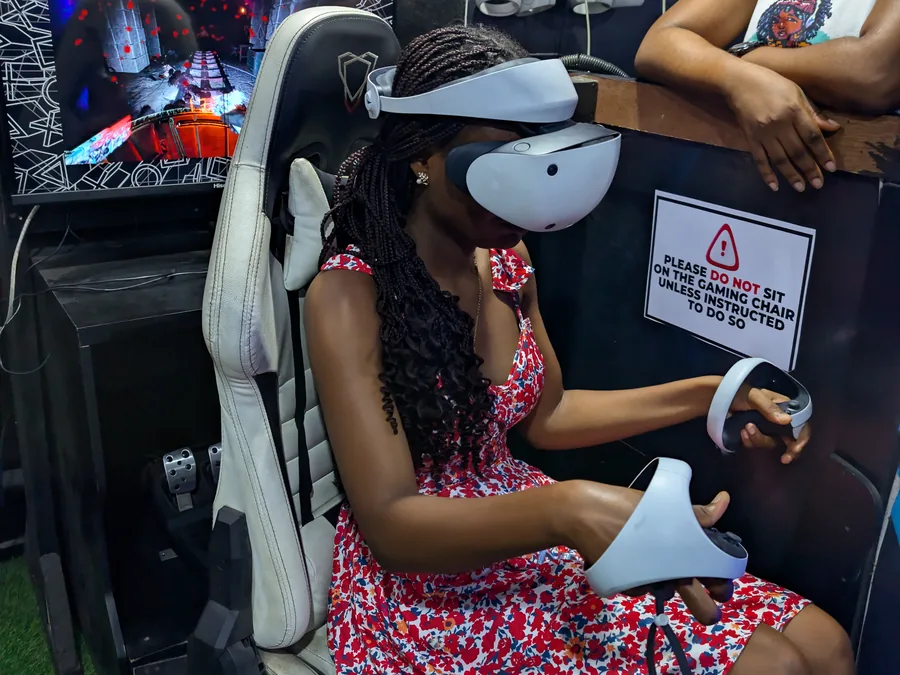 Content creator testing a VR headset at Player One Game Cafe Lagos