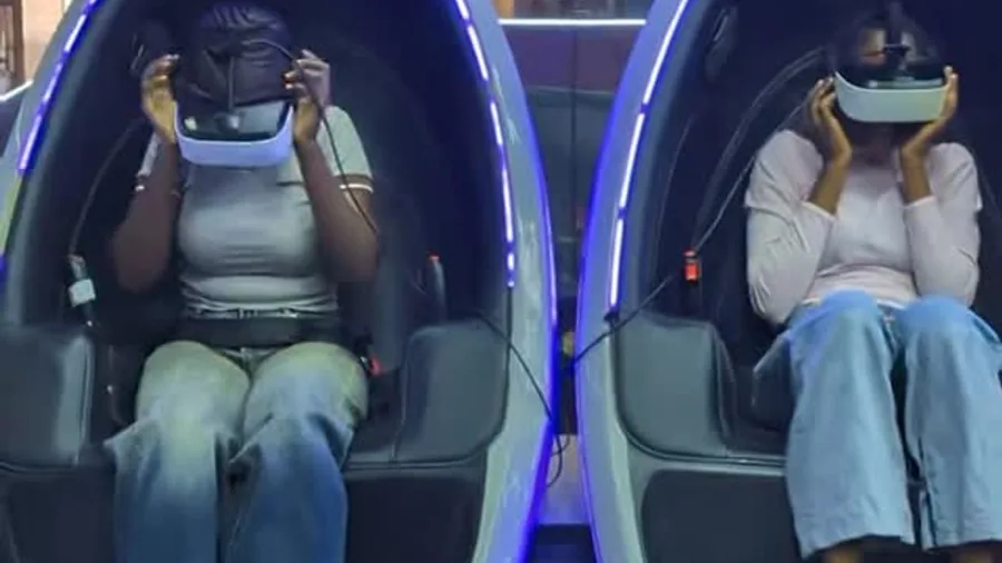 Two guests sharing a VR pod date night experience at Player One Game Cafe