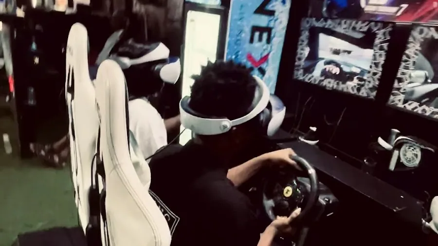 Guest racing on a simulator rig at Player One Game Cafe