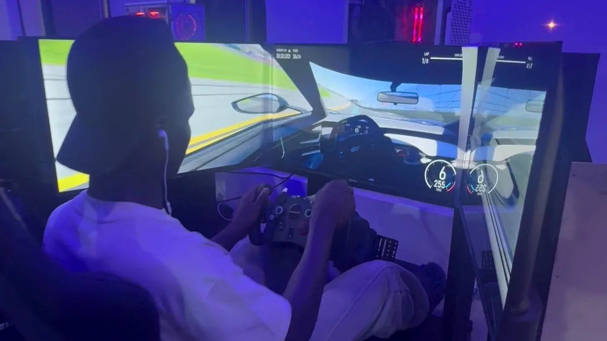 Triple-screen racing simulator session at Player One Game Cafe Victoria Island